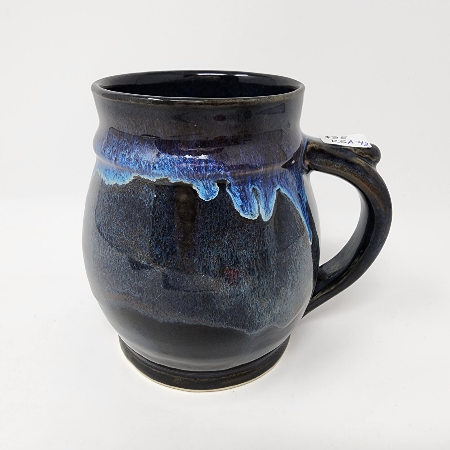 Shapely Black Glazed Mug with Blue Drip Accents